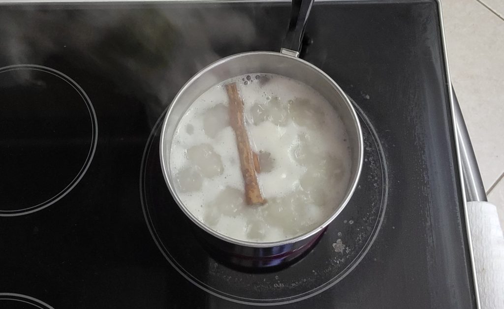 The first step in making Nicaraguan Rice Pudding is to boil the rice with water and aromatics.