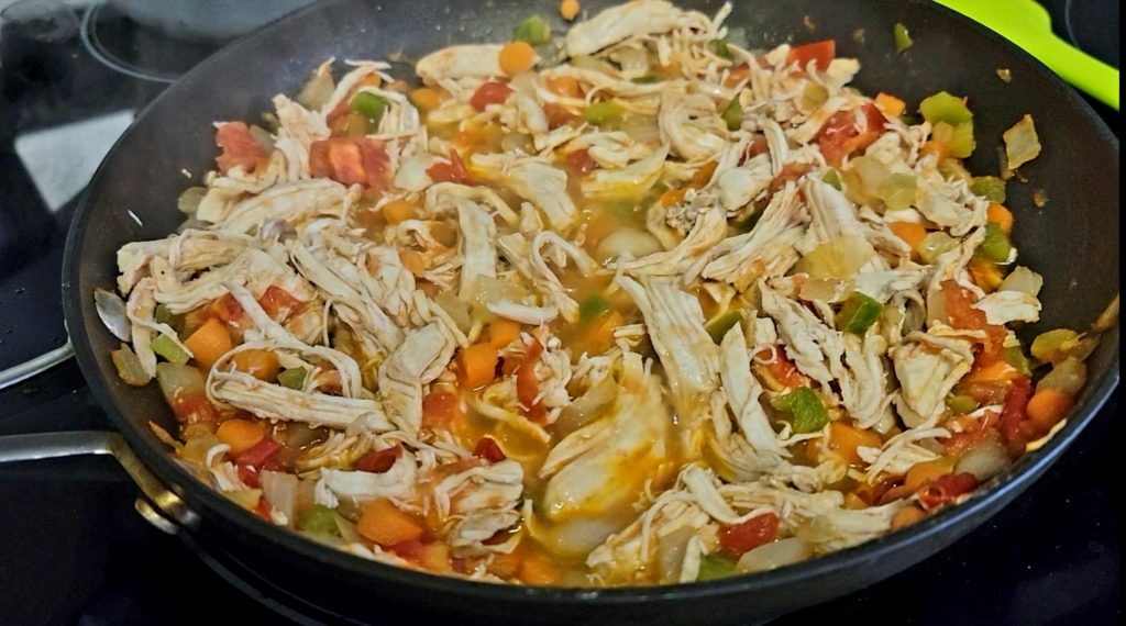 Nicaraguense Arroz A La Valenciana includes sauteed carrots, onions, celery, green peppers and tomatoes.