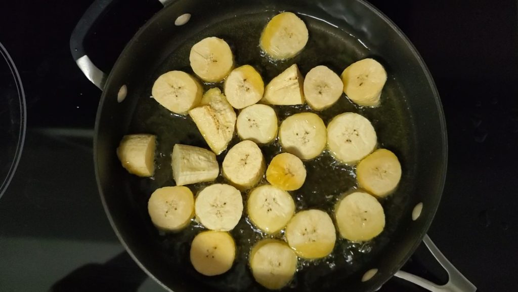 To make puerto rican mofongo, first fry green plantains until golden and tender.