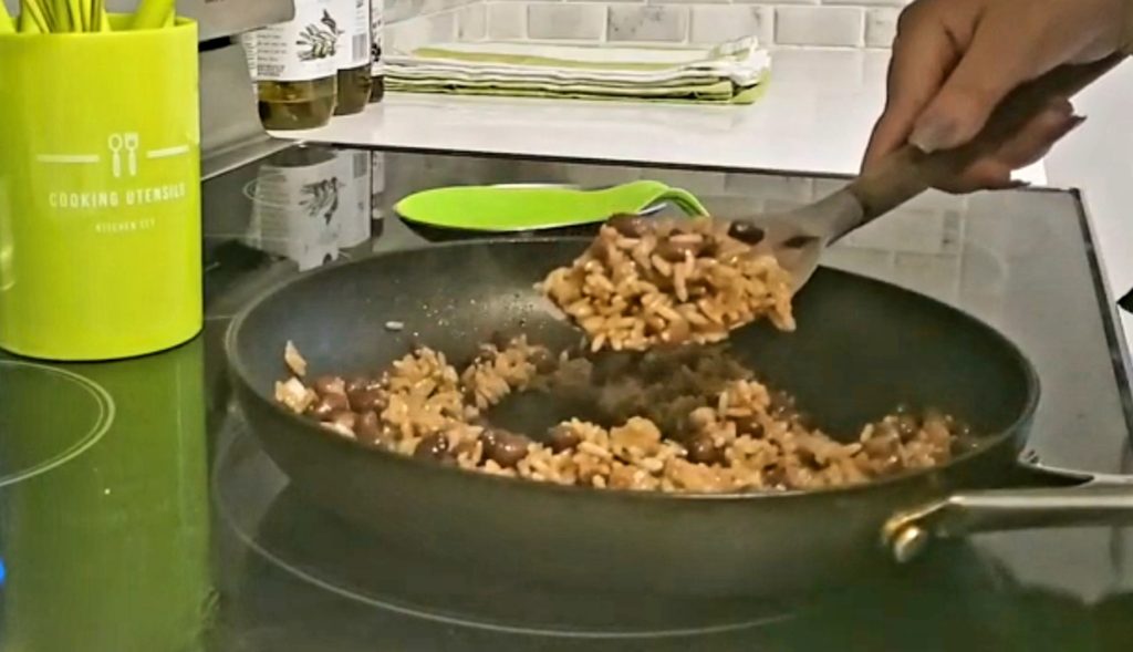 To make Nicaraguan Gallo Pinto start by frying day old rice and cooked red beans until they are slightly blistered.