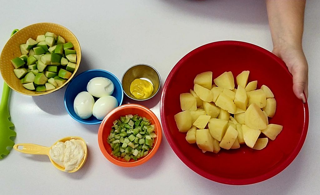 Puerto Rican Potato Salad is made with eggs, apples, celery along with mayo and other ingredients.